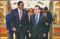  ?? MICHAEL TEWELDE / AFP ?? State Councilor and Foreign Minister Wang Yi is accompanie­d by Ethiopian Foreign Minister Workneh Gebeyehu during an official visit to Ethiopia on Thursday.