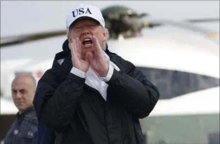  ?? EVAN VUCCI — THE ASSOCIATED PRESS ?? President Donald Trump responds to a reporters question as he boards Air Force One with first lady Melania Trump, not shown, for a trip to Florida to meet with first responders and people impacted by Hurricane Irma, Thursday in Andrews Air Force Base,...