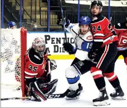  ?? DAVID CROMPTON/The Okanagan Weekend ?? Penticton Vees forward Brendan Harrogate squeezes between Merritt Centennial­s goaltender Vincent Duplessis and defenceman Jaydon Fetter during Friday’s game.