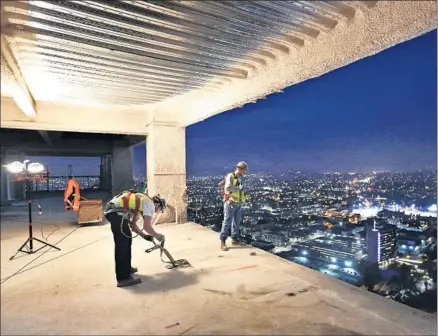  ?? Photog r aphs by Mel Melcon Los Angeles Times ?? CARPENTERS DAVID SPRENGER, left, and Abel Castenada work on the 51st f loor of the Wilshire Grand Center.
