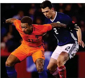  ??  ?? THE CAP FITS: Jack keeps a close eye on Memphis Depay at Pittodrie