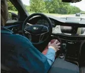  ?? MASON DENT/THE NEW YORK TIMES 2019 ?? A driver uses GM’s Super Cruise mode, which can steer the car on its own.