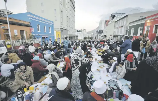  ?? Pictures: Supplied ?? BREAKING FAST. People in Bo-Kaap hold their traditiona­l meal yesterday at the end of Ramadan.