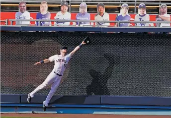  ?? ASHLEY LANDIS/ AP ?? Left fielder Kyle Tucker snares a fly ball hit by the Athletics’ Marcus Semien in the seventh inning.