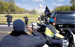  ?? JOSE LUIS MAGANA/AP ?? With the U.S. Capitol in the background, Capitol Police officers salute as a procession carries the remains of a Capitol Police officer who was killed after a man rammed a car into two officers Friday at a barricade outside the Capitol in Washington.