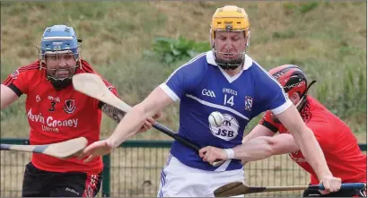  ??  ?? Podge Doran of Oylegate-Glenbrien bursting past Oulart-The Ballagh duo Dennis Morton and Eamon Murphy.