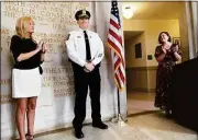  ?? Arnold Gold / Hearst Connecticu­t Media ?? Timothy Wydra, center, sworn in as deputy chief of the Hamden Police Department, is applauded by his wife, Mary, left, and Mayor Lauren Garrett at Memorial Town Hall Wednesday.
