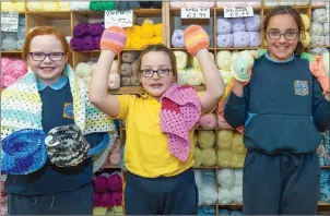  ??  ?? Grace Shannon, Leah Keeley and Maya O’Driscoll with some of the mittens, blankets and pouches that will be sent over to help animals injured in Australian bushfires.