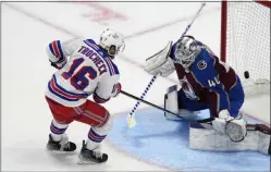  ?? DAVID ZALUBOWSKI — THE ASSOCIATED PRESS ?? Rangers center Vincent Trocheck, left, scores against Avalanche goaltender Alexandar Georgiev in the shootout round Thursday’s game at Ball Arena in Denver.