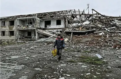  ?? Picture: Reuters ?? A local resident walks in front of a building heavily damaged by Russian military strikes in the town of Orikhiv, amid Russia’s attack on Ukraine.