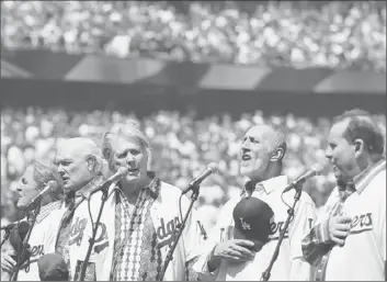  ?? Robert Gauthier Los Angeles Times ?? MEMBERS of the Beach Boys reunion — Bruce Johnston, left, Mike Love, Brian Wilson, David Marks, Jeffrey Foskett — sing the national anthem at Dodger Stadium in April. They play the Hollywood Bowl on Saturday.