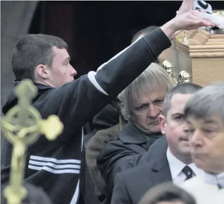  ??  ?? CLOCKWISE FROM ABOVE: A member of St. Peregrine’s Gaelic Football Club places a scarf on the coffin of Ian McKeever after the funeral Mass at The Church of St. Laurence O’Toole, Roundwood; Students from Cresent College, Limerick who climbed Kilamanjar­o...