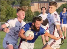  ??  ?? Conor Carty gets past Aaron Maddock and Jack O’Connor.