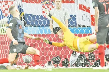  ??  ?? Croatia forward Ivan Perisic scores past England’s Jordan Pickford during their World Cup semi-final in Moscow. - AFP photo