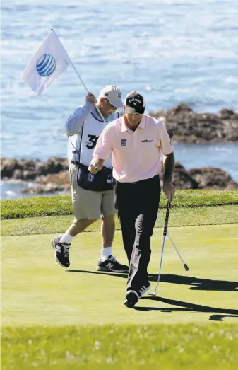  ?? Michael Macor / The Chronicle ?? Jim Furyk departs the eighth green at Pebble Beach after saving par on the hole. He leads the tournament by one shot as he seeks his first victory since September 2010.