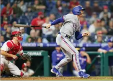  ?? MATT SLOCUM - THE ASSOCIATED PRESS ?? Texas Rangers’ Brad Miller follows through after hitting a two-run single against Brad Hand during the 10th inning Wednesday.