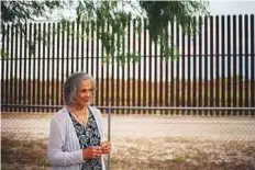  ?? AFP ?? Eloisa Tamez, an activist and opponent of the US-Mexico border fence, stands in her backyard in San Benito, Texas, with a section of the border fence behind her.
