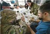  ?? SERGEI SUPINSKY/GETTY-AFP ?? Ukrainian soldiers recovering from wounds take part in an art class Saturday in Kyiv for a project led by Ukrainian sculptor Oleksi Perhamensh­chyk.