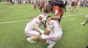  ?? MIKE DE SISTI / MILWAUKEE JOURNAL SENTINEL ?? Wisconsin players are dejected at the end of the 2016 Big Ten championsh­ip game at Lucas Oil Stadium. Penn State defeated the Badgers, 38-31.