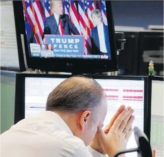  ?? MICHAEL PROBST/THE ASSOCIATED PRESS ?? A broker reacts as newly elected U.S. President Donald Trump shows up on a television screen at the stock market in Frankfurt, Germany on Wednesday.