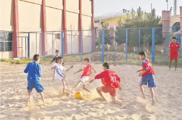  ??  ?? Afghan youths play beach football at Ghazi stadium in Kabul in this July 2 file photo. — AFP photos