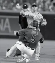  ?? ASSOCIATED PRESS ?? PHILADELPH­IA PHILLIES shortstop Scott Kingery turns the double play while avoiding Arizona Diamondbac­ks’ Alex Avila (5) on a ball hit by Patrick Corbin in the fourth inning, Wednesday in Phoenix.