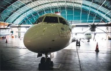  ?? Ali Mohammadi / Bloomberg ?? A new twin engine ATR 72-600 turboprop aircraft sits in a hangar following its arrival at Mehrabad Internatio­nal airport in Tehran, Iran, on Aug. 5.