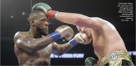  ?? PICTURE: AP ?? DEONTAY Wilder, left, and Tyson Fury, of England, trade punches during a WBC heavyweigh­tchampions­hip boxing match onSaturday.