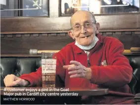  ?? MATTHEW HORWOOD ?? A customer enjoys a pint in the Goat Major pub in Cardiff city centre yesterday