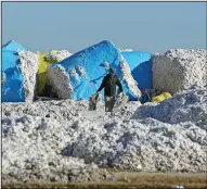  ?? (Arkansas Democrat-Gazette/Colin Murphey) ?? A worker helps in the cleanup effort Monday at the Adams Land Co. cotton gin plant in Leachville.