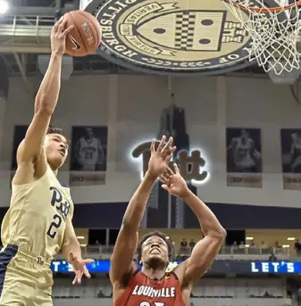  ?? Matt Freed/Post-Gazette ?? Trey McGowens drives to the basket against Louisville’s Steven Enoch in the Panthers’ 89-86 overtime win Jan. 9 at Petersen Events Center. Getting to the rim is something the freshman guard has found difficult in the Panthers’ six-game losing streak.