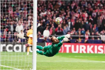  ?? — AFP photo ?? Atletico Madrid goalkeeper Oblak stops the ball in the penalty shoot-out during the UEFA Champions League last 16 second leg match against Inter Milan at the Metropolit­ano stadium in Madrid.