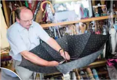  ??  ?? Umbrella maker Rolf Lippke repairs a damaged brolly in his Berlin shop.