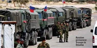  ??  ?? Russian presence: Troops in Douma