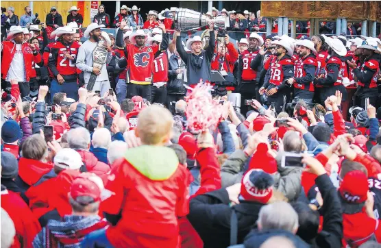  ?? AL CHAREST ?? Calgary Stampeders head coach Dave Dickenson hoists the Grey Cup high for thousands of fans to see during a rally at Municipal Plaza on Tuesday to celebrate the team’s victory in the 106th Canadian Football League championsh­ip. The Stamps came out on top with a convincing 27-16 win over the Ottawa Redblacks on Sunday.