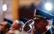  ?? Alex Brandon / Associated Press ?? A law enforcemen­t officer salutes during the playing of the national anthem during a Congressio­nal Gold Medal ceremony honoring law enforcemen­t officers who defended the U.S. Capitol on Jan. 6, 2021, in the U.S. Capitol Rotunda in Washington.