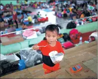  ?? DARREN WHITESIDE / REUTERS ?? A child eats noodles at a sports arena in Klungkung on the resort island of Bali, Indonesia, on Sunday. The arena has become a temporary evacuation center for people living near Mount Agung, which could erupt soon.