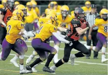  ?? CLIFFORD SKARSTEDT/EXAMINER ?? Peterborou­gh junior varsity Wolverines slotback Mack McFarlane eludes a swarm of Huronia Stallions players during Ontario Football Conference Ramsay Division Final with on Saturday at Thomas A. Stewart Athletic Field in Peterborou­gh.