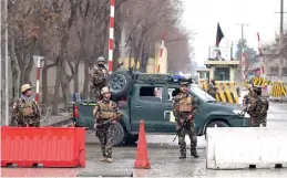  ??  ?? Afghan security personnel stand guard near the site of a suicide bombing in Kabul on Saturday.