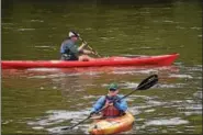  ?? MARIAN DENNIS – DIGITAL FIRST MEDIA ?? Two kayakers float around as their fellow sojourners make their way to the riverbank in Royersford Wednesday.