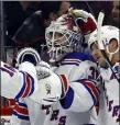  ?? Associated Press ?? Rangers goaltender Igor Shesterkin, second right, is mobbed by teammates after a win Tuesday.