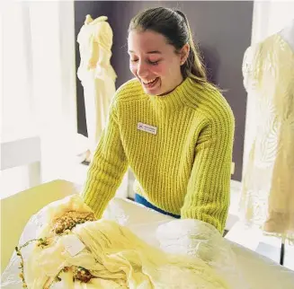  ?? Brian A. Pounds/Hearst Connecticu­t Media ?? Programs and Collection­s Director Nicole Carpenter unboxes a 1920’s bridal veil for display in the “I Thee Wed” exhibit of vintage wedding dresses at the Wesport Museum at 25 Avery Place in Westport on March 8. The exhibit opened to the public on March 10.