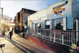  ??  ?? NEW STORES in Lincoln Heights haven’t been protested as they have in Boyle Heights. When this deli and bottle shop replaced a meat market, complaints were confined to community chatter.