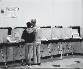  ?? AP/DAVID GOLDMAN ?? A voter casts a ballot Tuesday in Atlanta in a special election to fill the U.S. House seat vacated by Tom Price, who resigned to serve as U.S. health secretary.