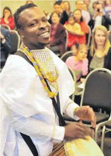  ?? PHOTO: CHRISTINE O’CONNOR ?? Dream come true . . . New citizen Robert Fugah, originally from Ghana, performs a traditiona­l African drum song in front of the other new citizens at the end of a ceremony in the Glenroy Auditorium yesterday.