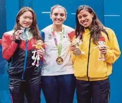  ??  ?? Nicol David (right) showing her World Games squash bronze medal with silver medallist Joey Chan of Hong Kong (left) and gold medallist Camille Serme of France in Wroclaw, Poland on Friday.