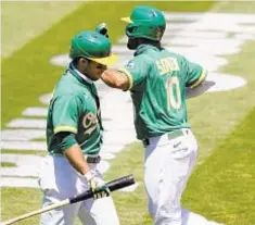  ?? GETTY ?? Marcus Semien of the Oakland Athletics is congratula­ted by Ramon Laureano hitting a home run on Saturday.