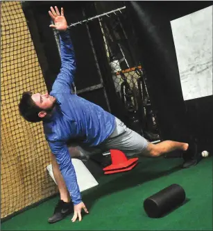  ?? Photos by Ernest A. Brown ?? North Smithfield native C.J. Dandeneau, above photo, and Cumberland native Chris Wright, right photo, warm up prior to the start of Wednesday’s workout at All About Sports, which is located in North Smithfield.