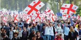  ??  ?? TBILISI: Supporters of Georgia’s main opposition United National Movement (UNM) party march yesterday.— AFP