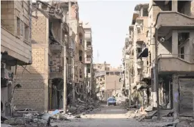  ?? AFP / Getty Images ?? Damaged buildings in the eastern Syrian city of Deir el-Zour show the intensity of recent fighting to oust Islamic State militants from their former stronghold.